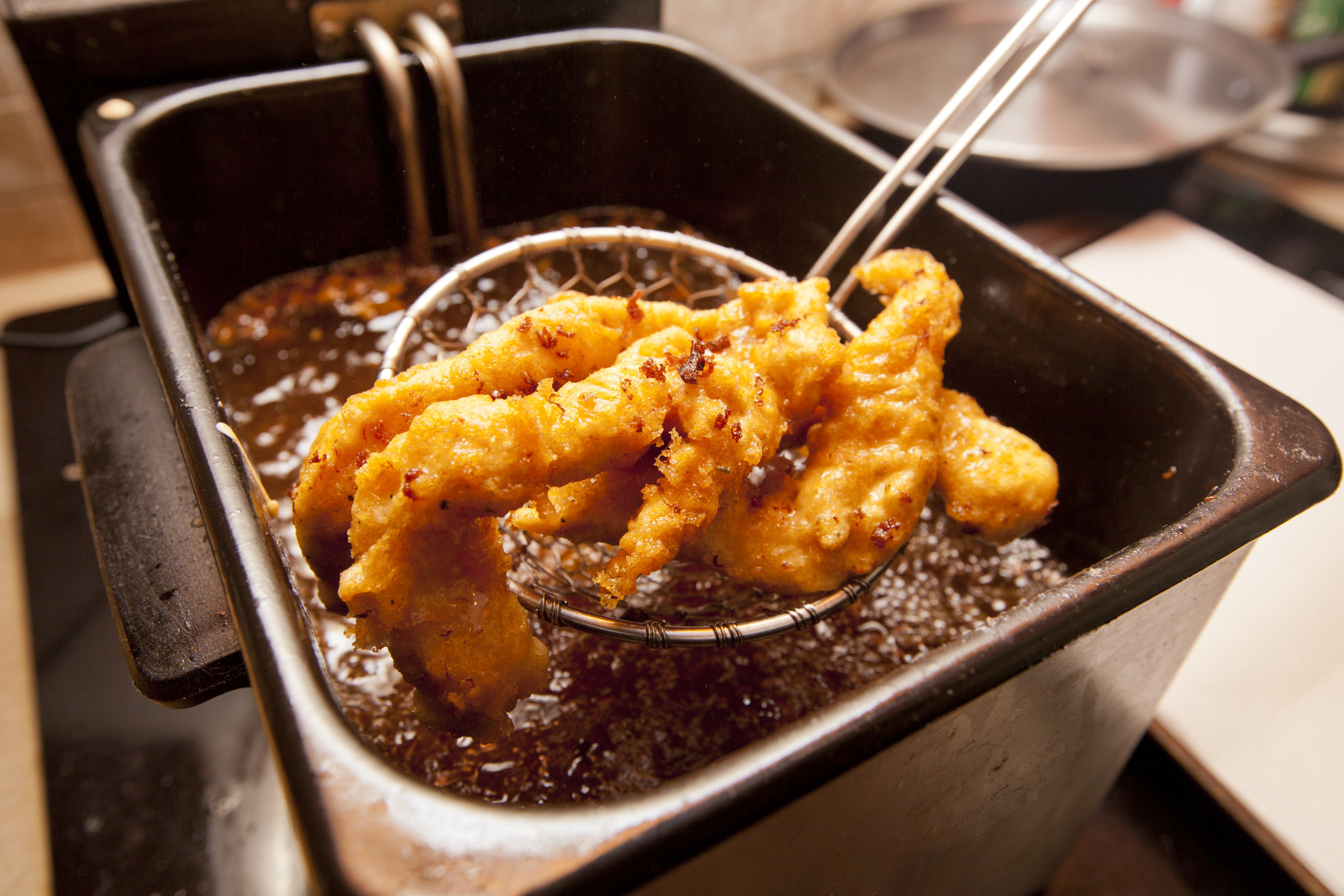 Chicken pieces in a fryer