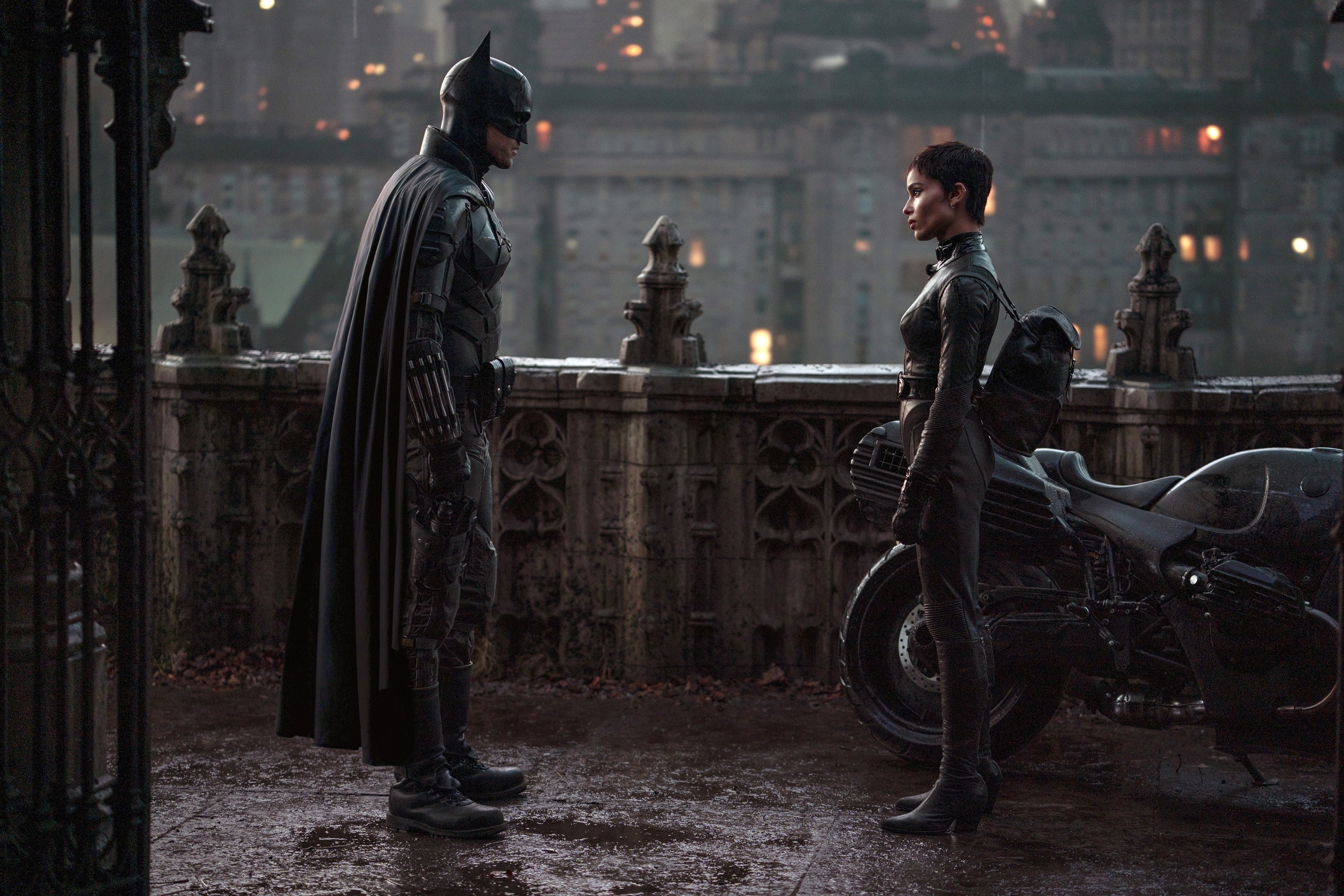 Batman and Catwoman stand in front of each other