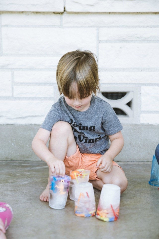 Blogger&#x27;s photo of their child playing with ice blocks with toys inside