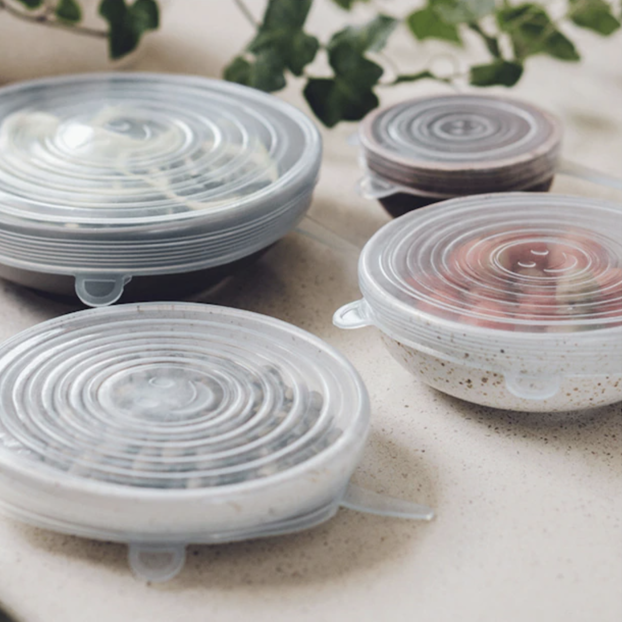 a set of stretchy silicone lids on several bowls