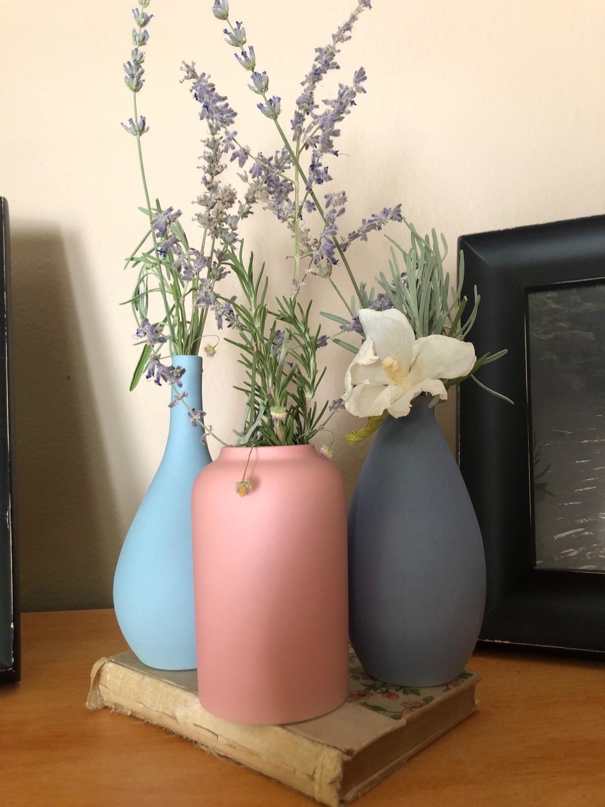 three of the vases in pink, blue, and purple