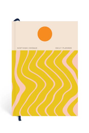 a planner with a sun and yellow and pink stripes on the cover
