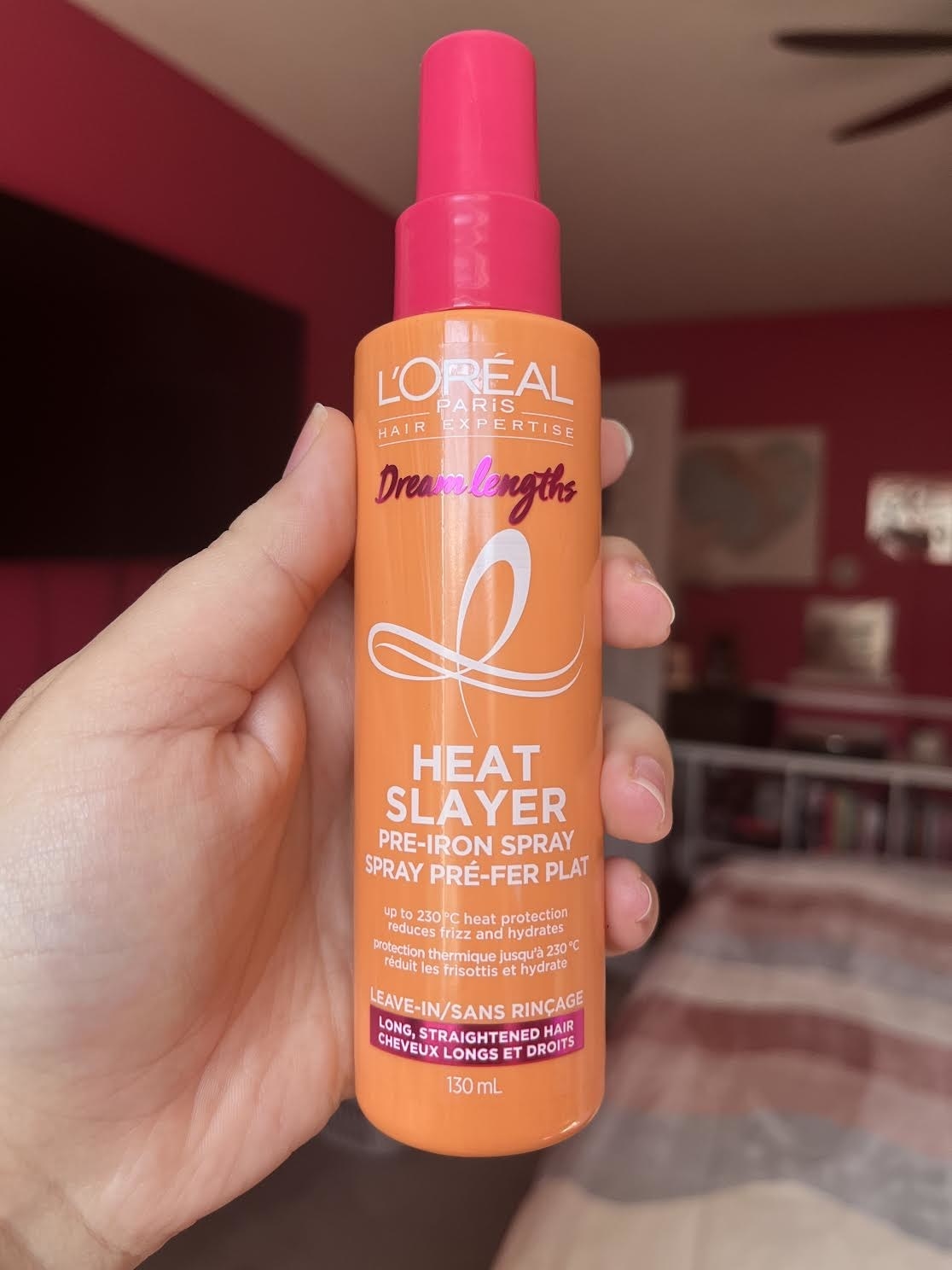 Bianca holding up the heat spray in a bedroom