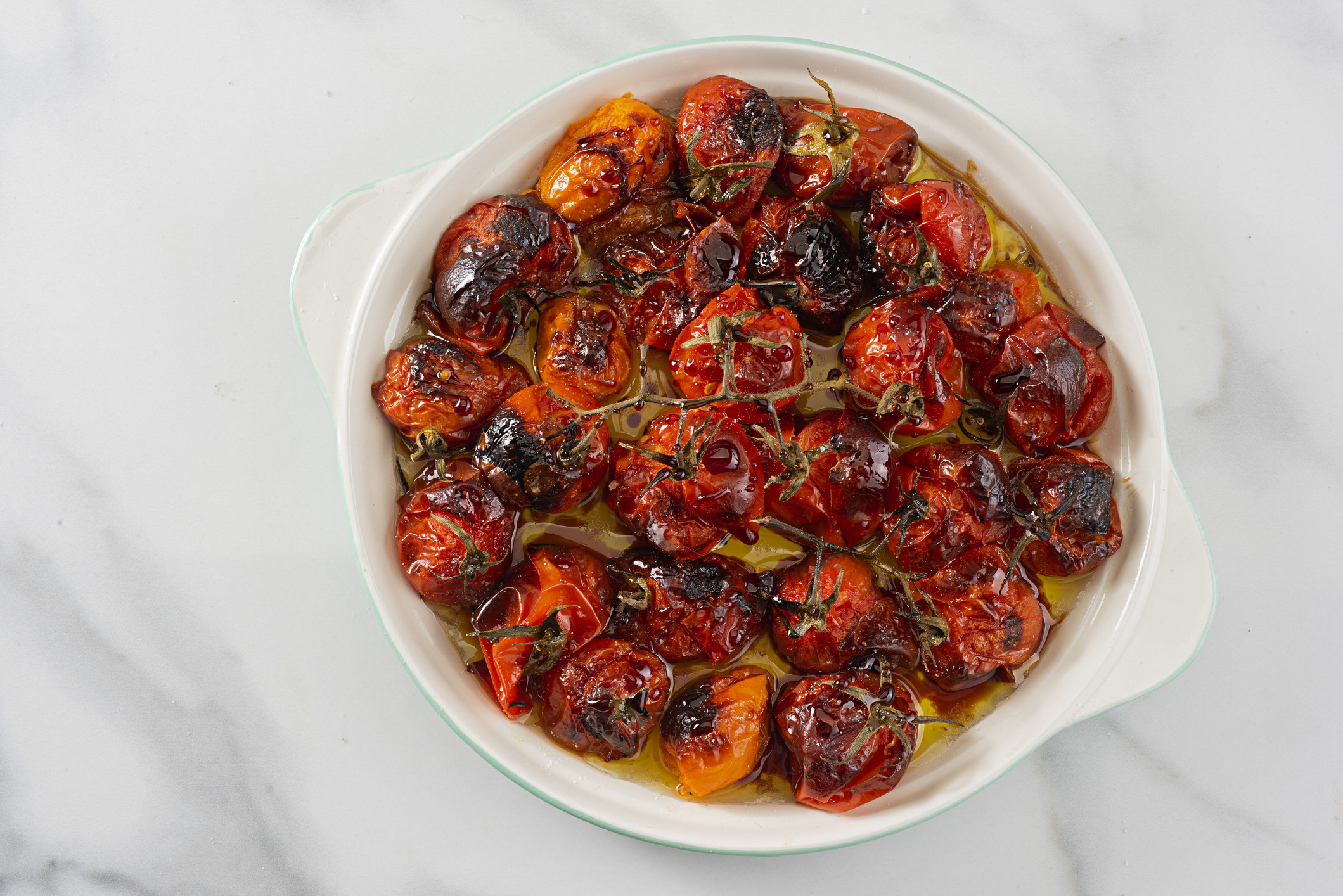 Blistered cherry tomatoes in olive oil.