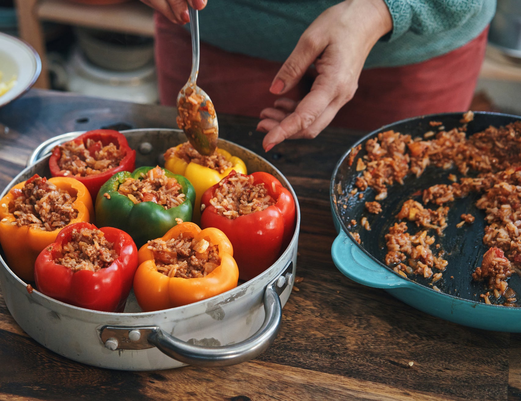 Spooning rice into bell peppers