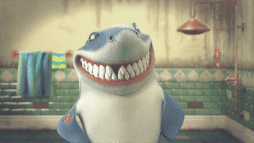 Gif of a shark smiling and his teeth falling out