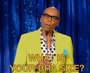 Gif of R Paul saying into a mic, &quot;What is your bra size?&quot;
