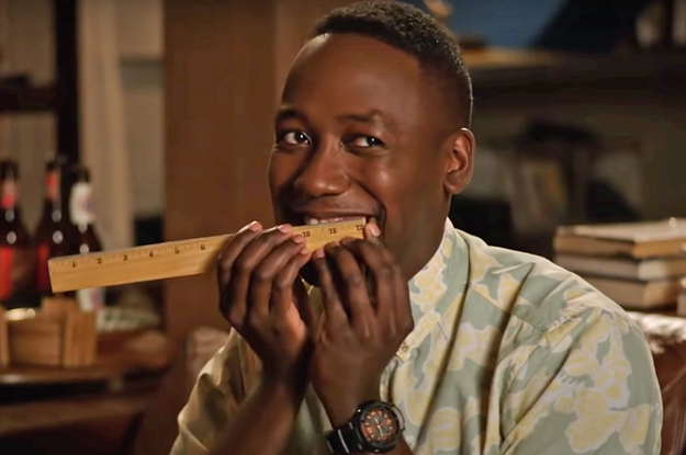Winston from New Girl measuring his smile with a ruler