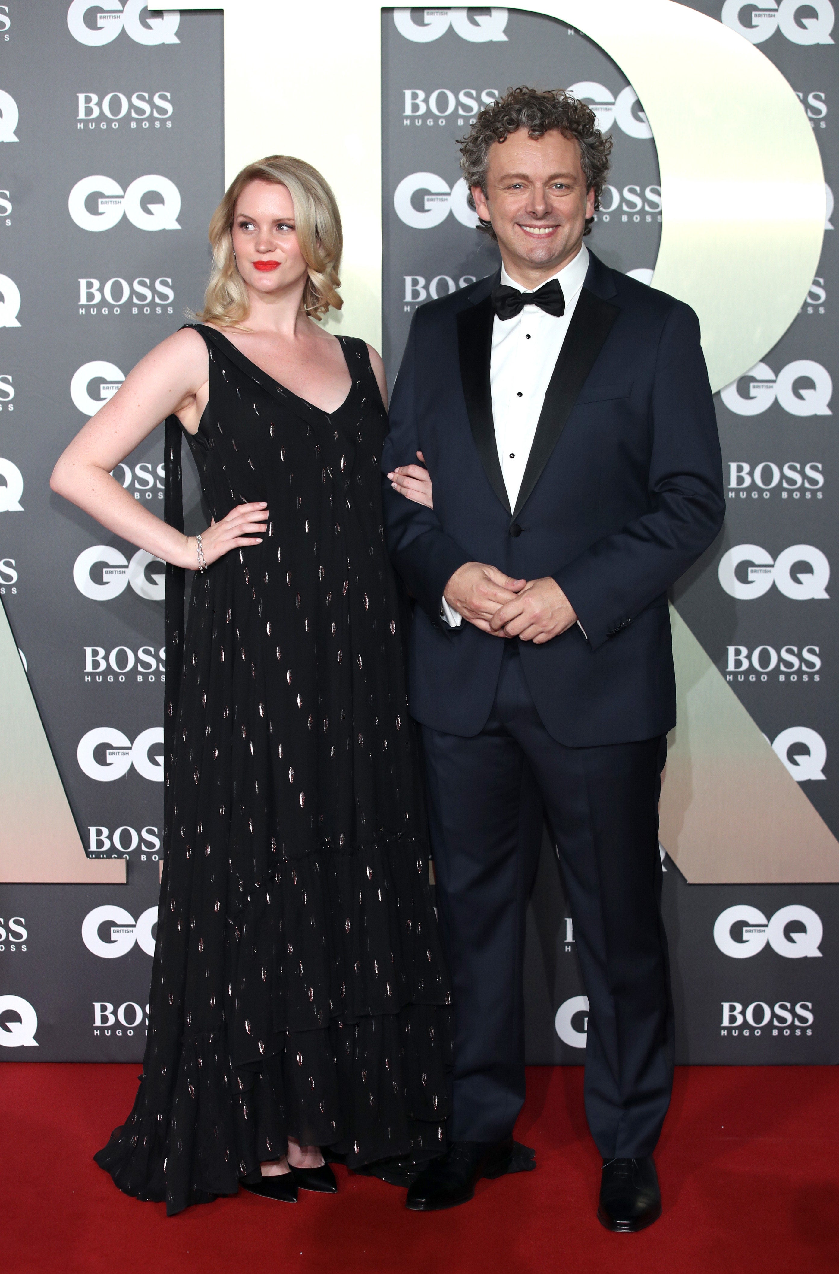 Michael and Anna link arms at an event