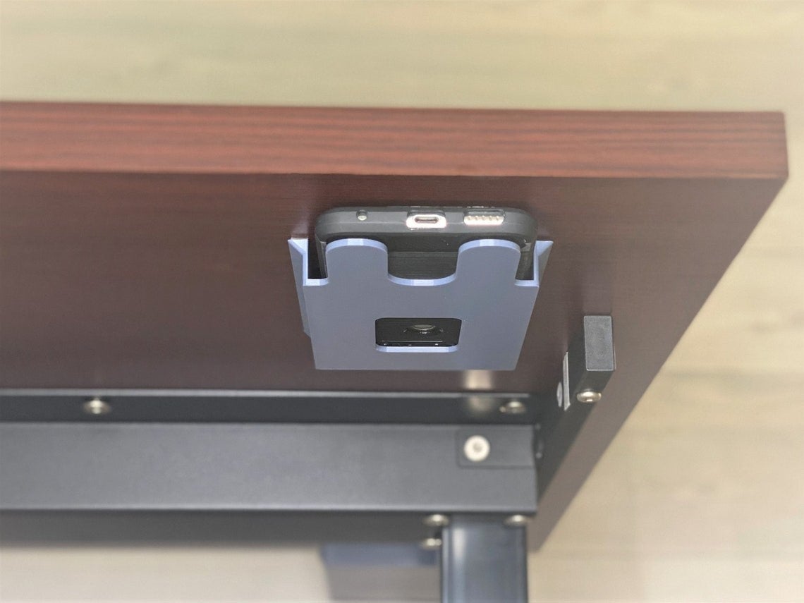 the phone holder placed under a desk