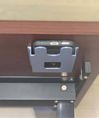 the phone holder placed under a desk