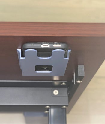 the phone holder placed under a desk