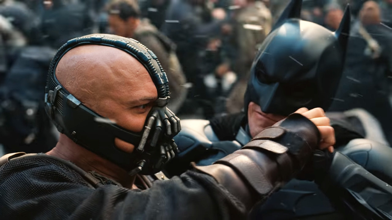 Tom Hardy as Bane and Christian Bale as Batman struggle in hand to hand combat