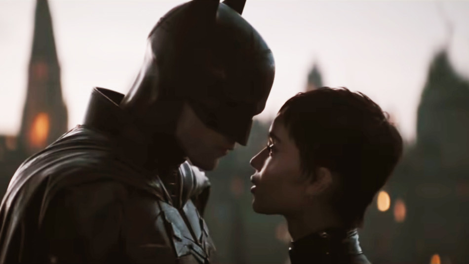 Robert Pattinson as The Batman and Zoë Kravitz as Catwoman approach each other for a kiss