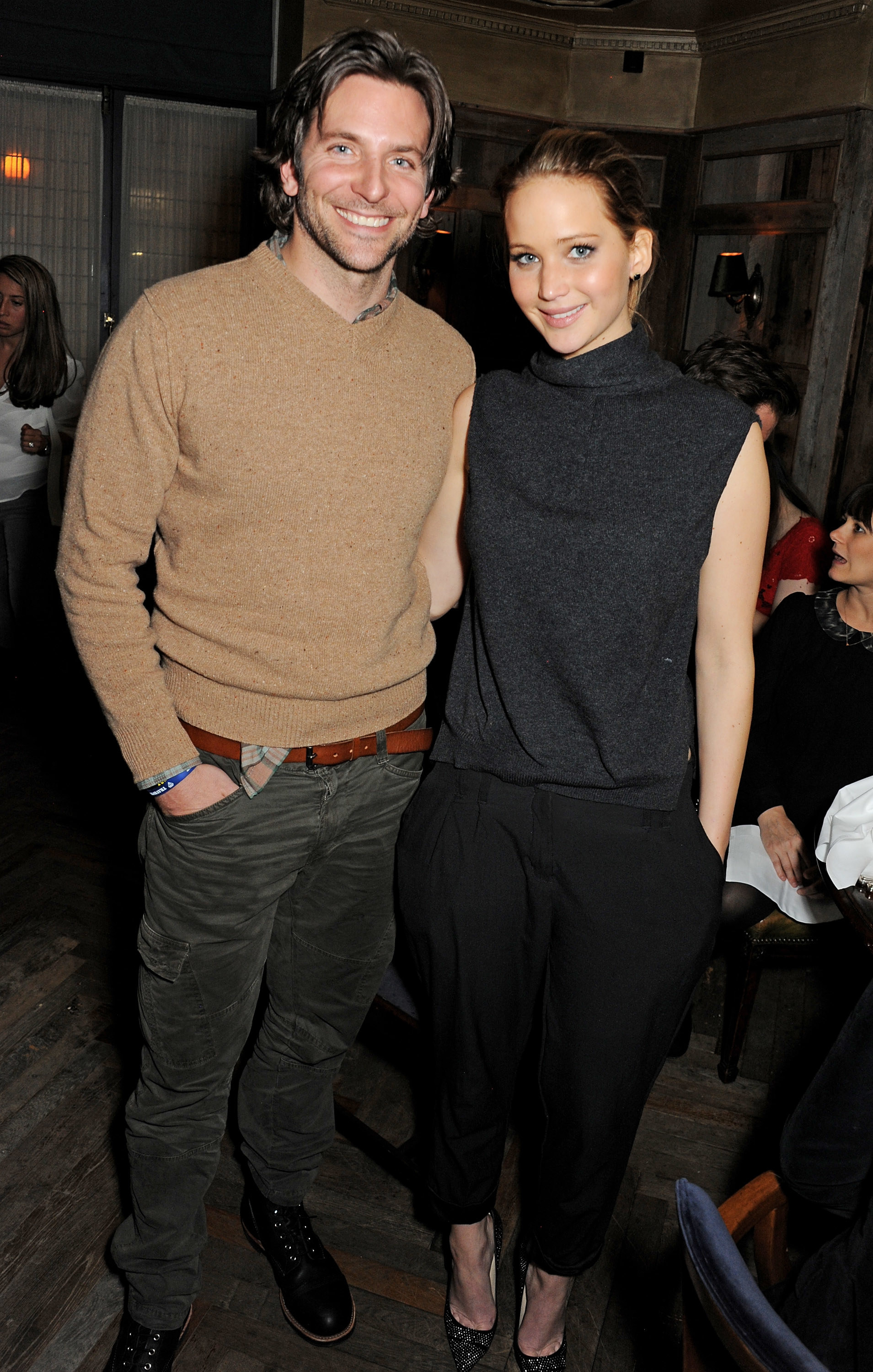 Bradley Cooper and Jennifer Lawrence smiling at the camera