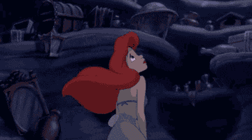 A gif of Ariel from The Little Mermaid looking up at her collection of stuff