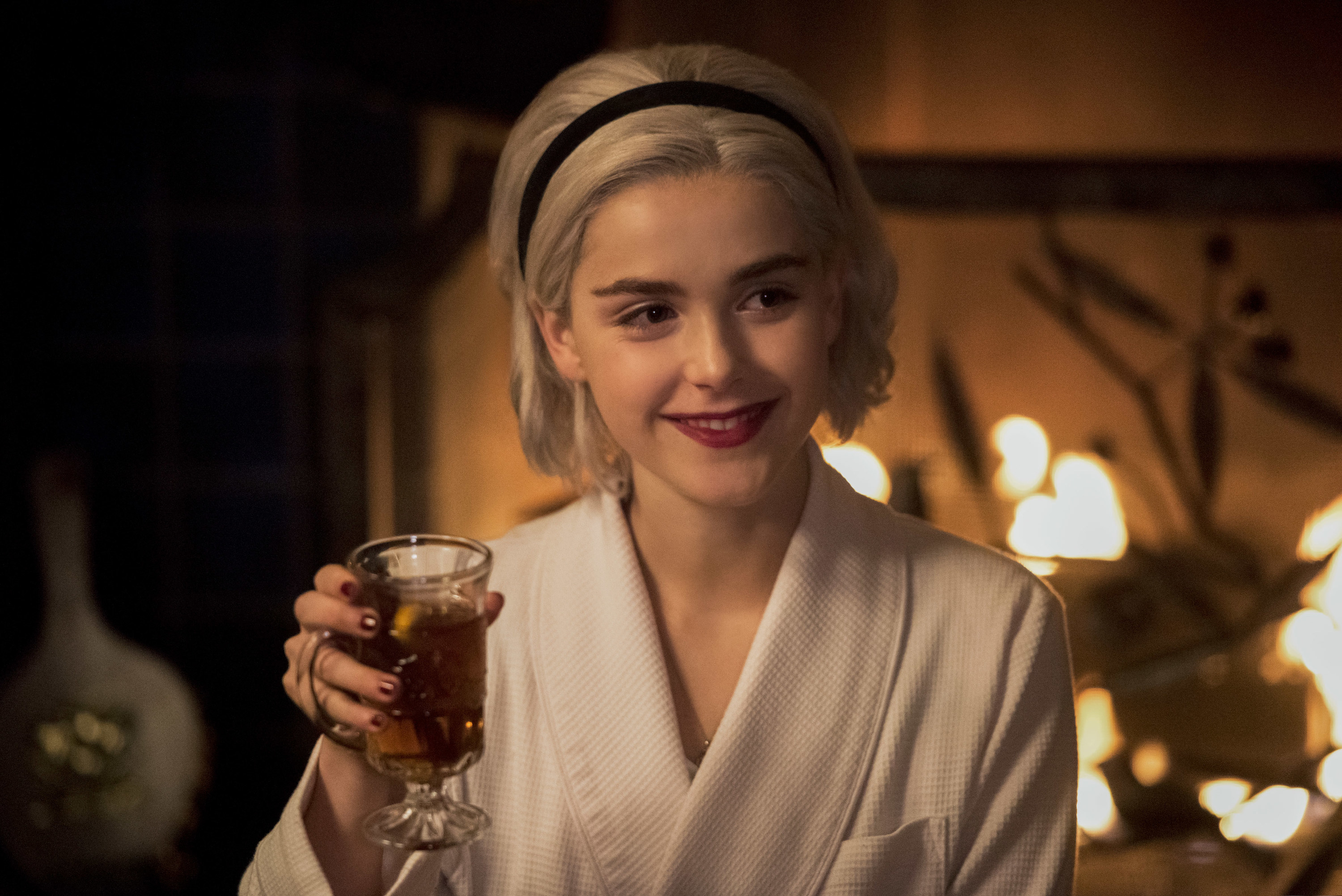 Sabrina holding a drink and smiling