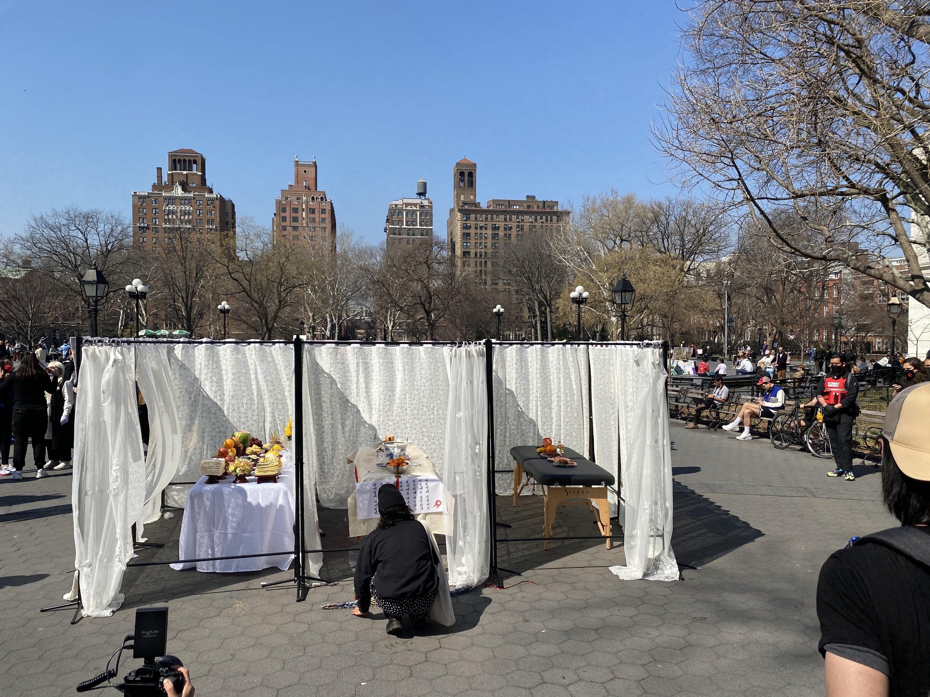 The New York City memorial created by Chong Gu set up like a massage business with tables and curtains.