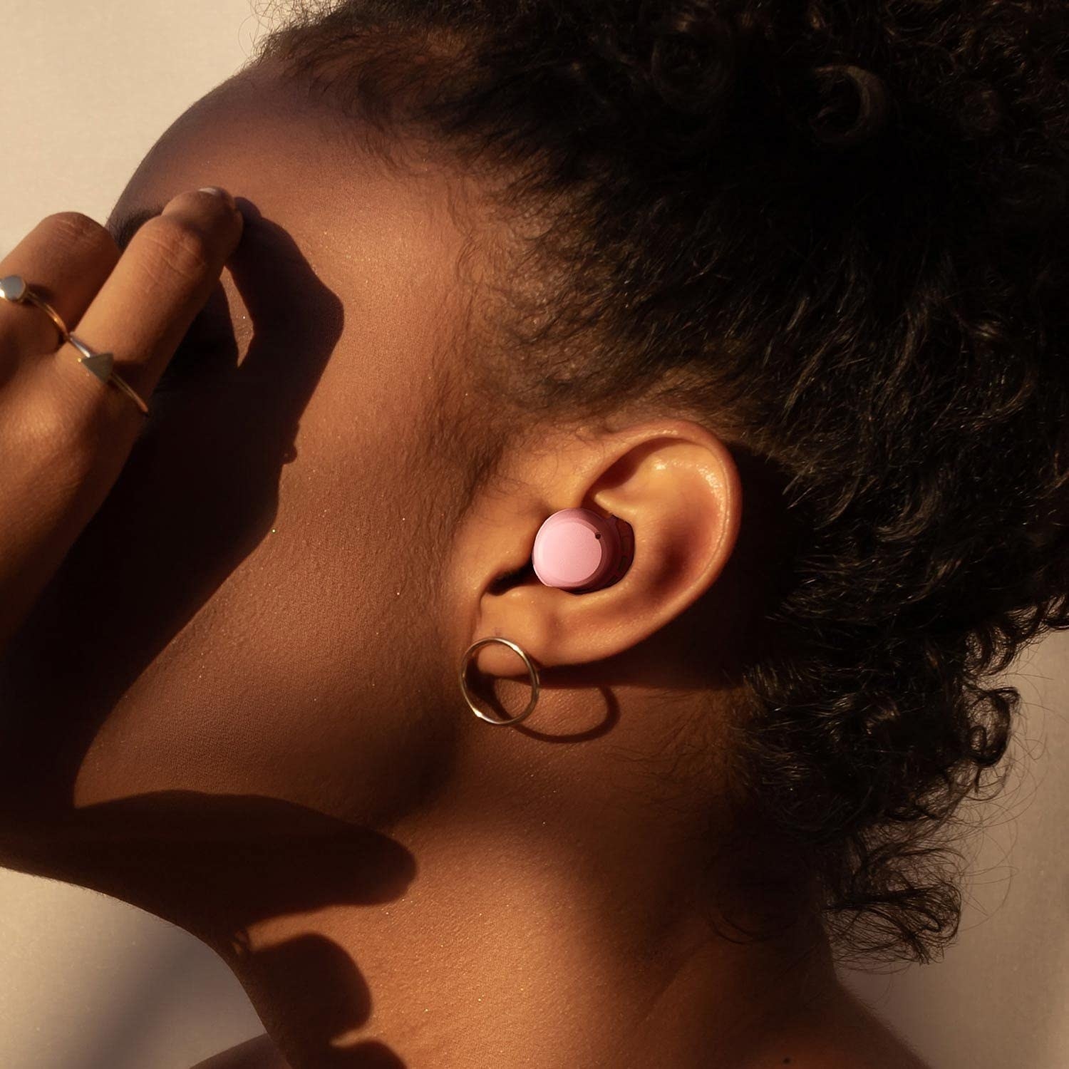 a profile photo of a person wearing the petite earbuds