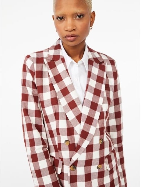 Model wearing red and white blazer over a white shirt
