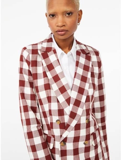 Model wearing red and white blazer over a white shirt