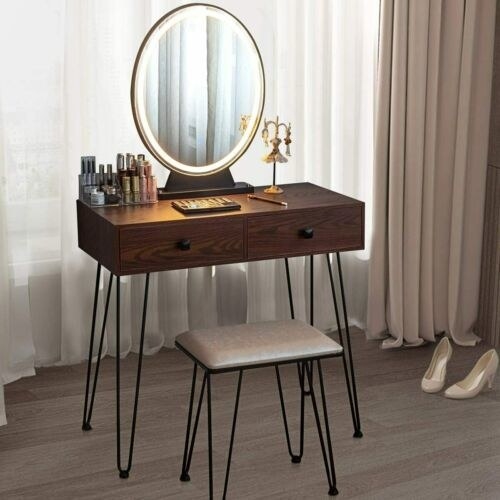 A dark wood vanity with black metal hairpin legs and a matching bench with a white cushion on top