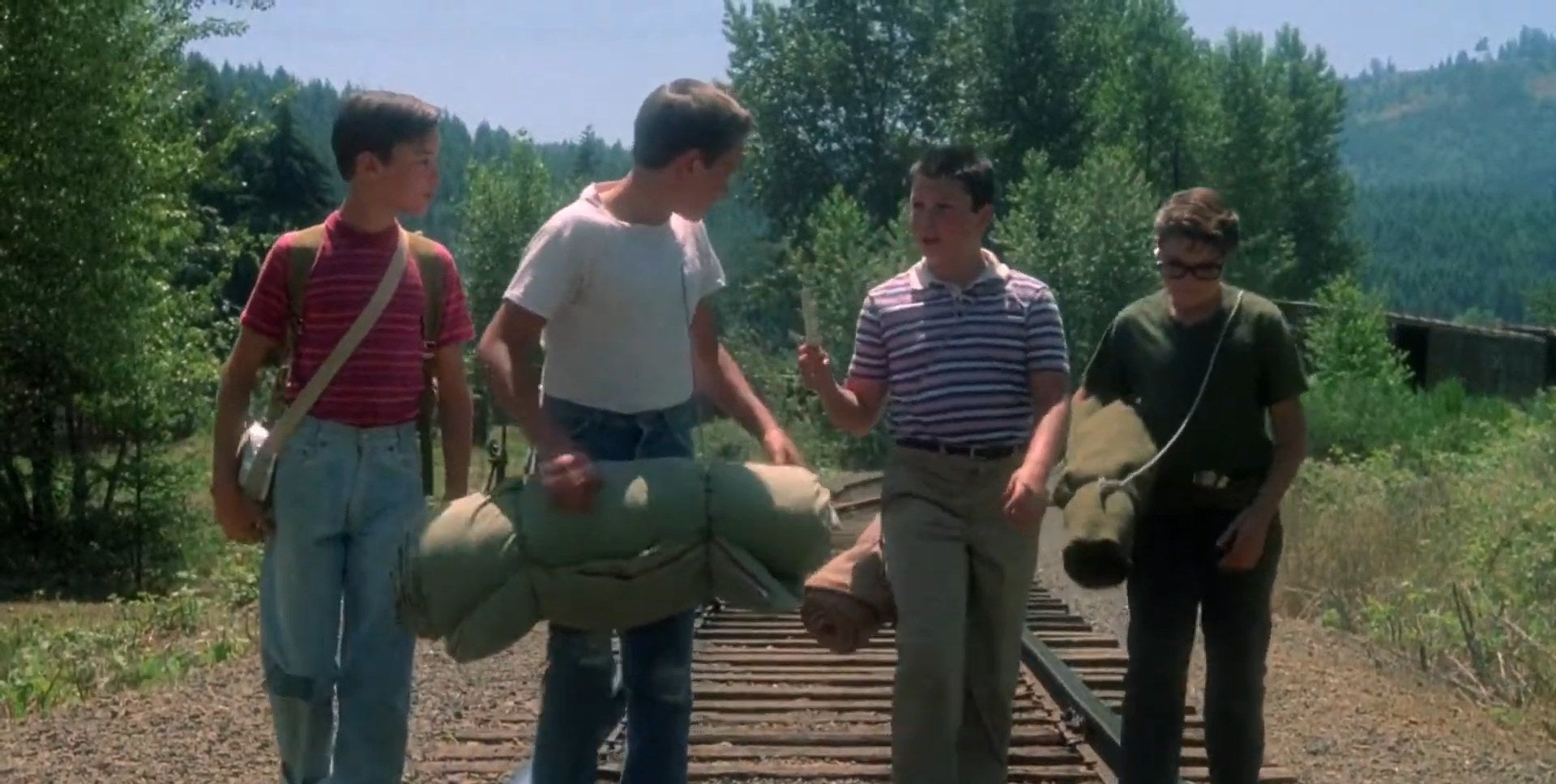 Gordie, Chris, Teddy, and Vern walking down a railroad in &quot;Stand by Me&quot;