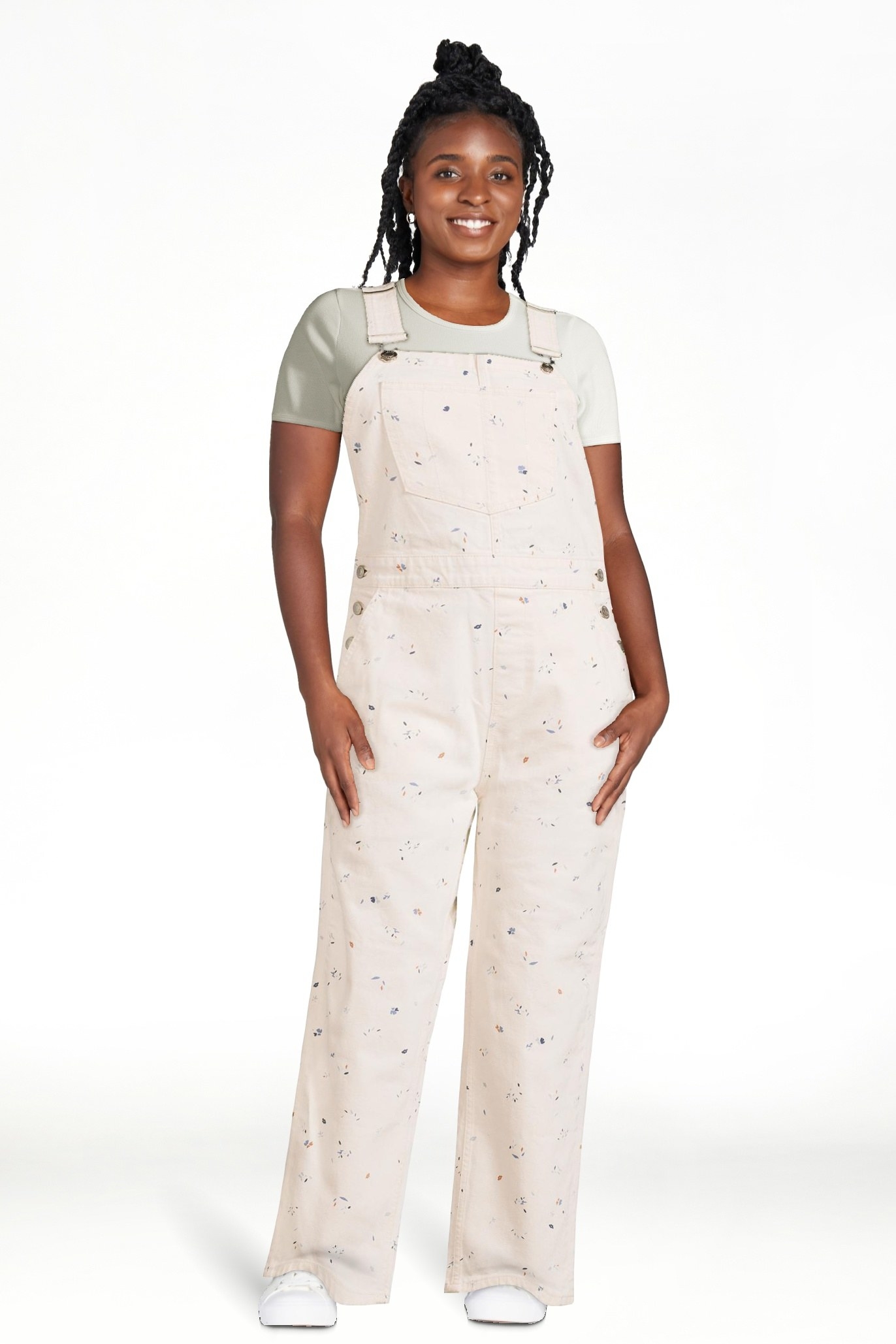 Model wearing white overalls with colorful details