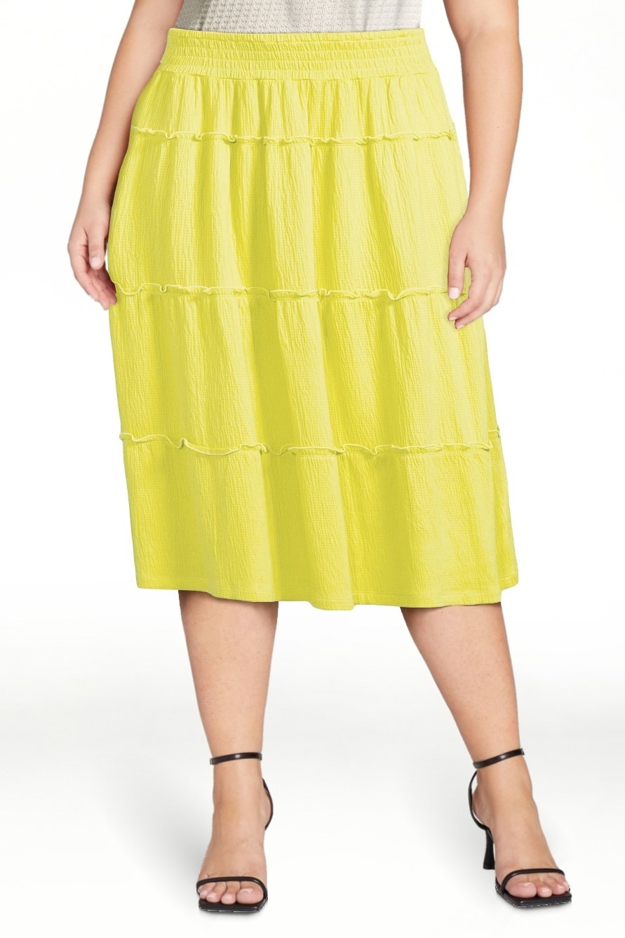 Model wearing yellow skirt