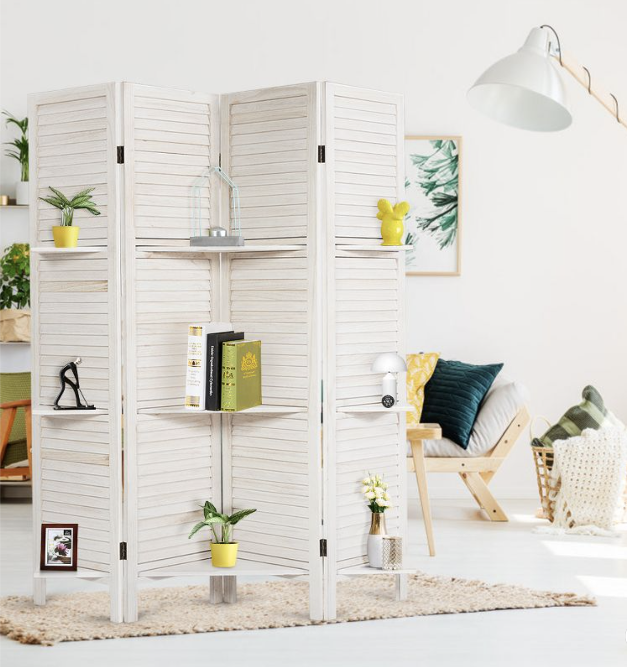 the white room divider with frames, plants and vases on the shelves