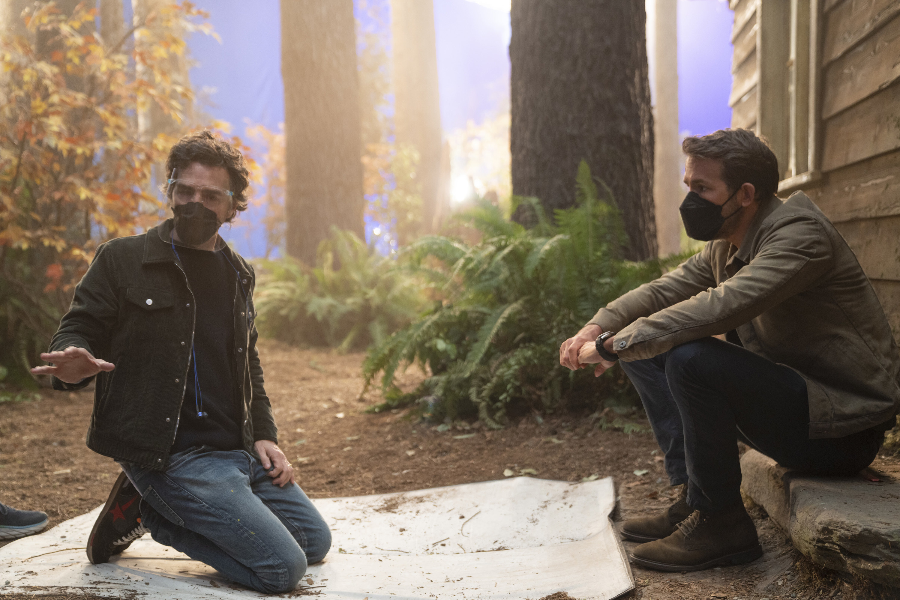 Shawn Levy and Ryan Reynolds talking on set with masks on