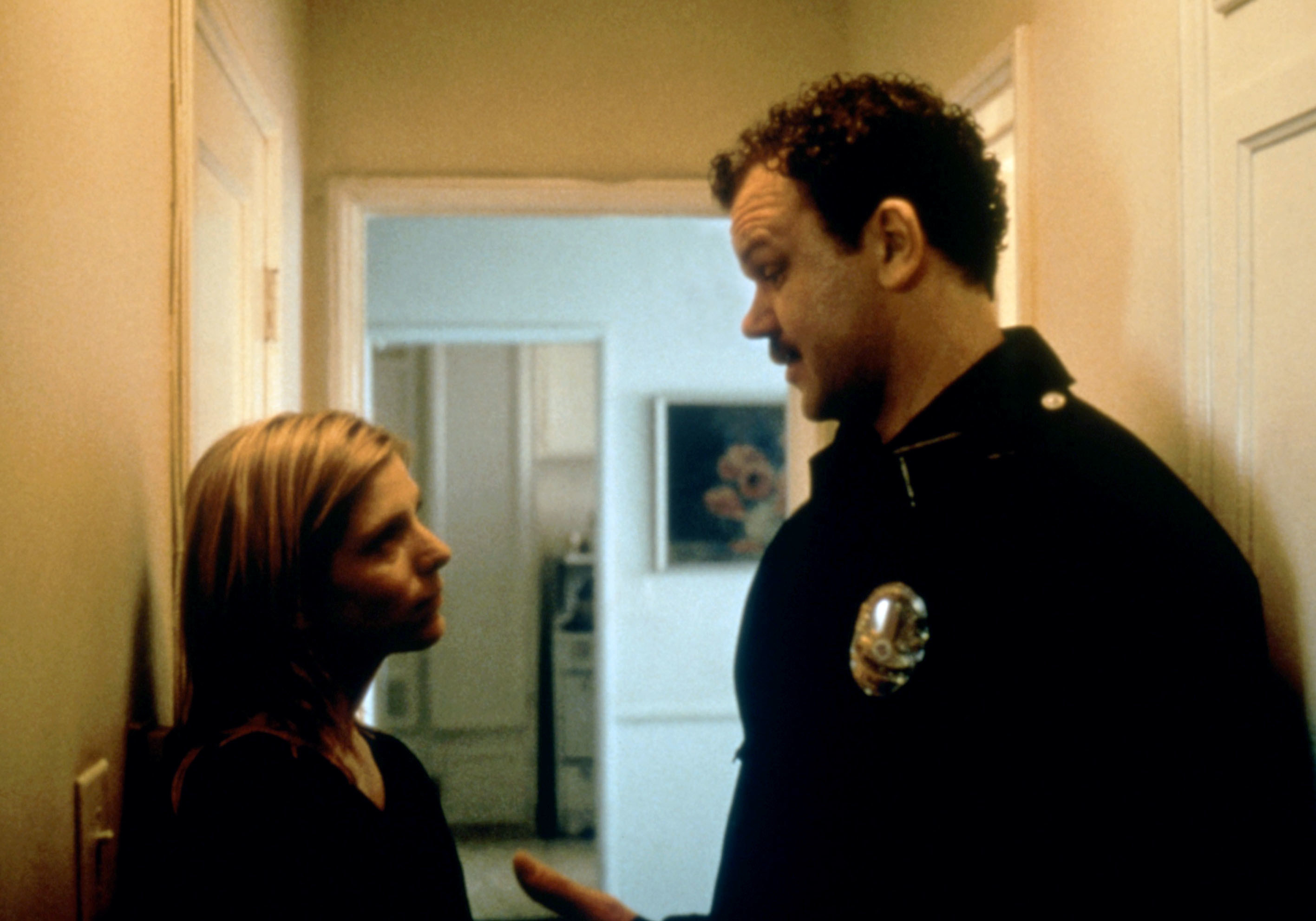 John and Melora standing in the corridor of a house