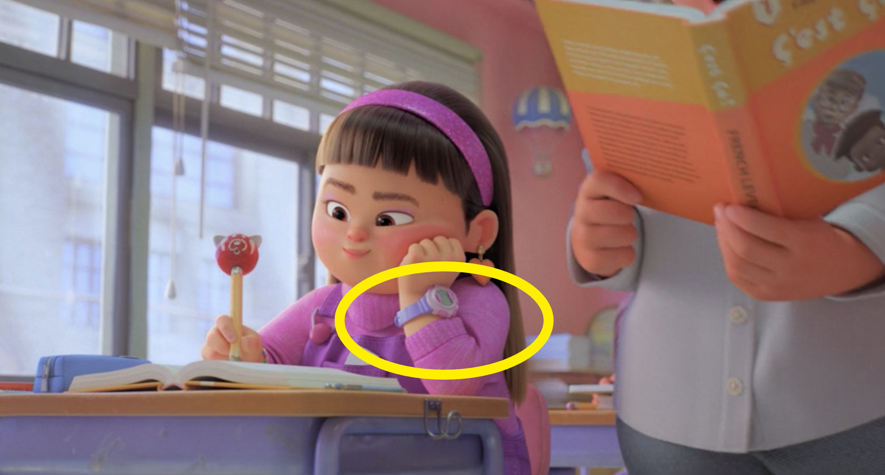 Abby writing in her book with her other hand on her cheek, and the watch circled