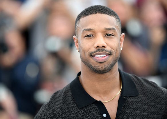 Michael B. Jordan posing on a red carpet 