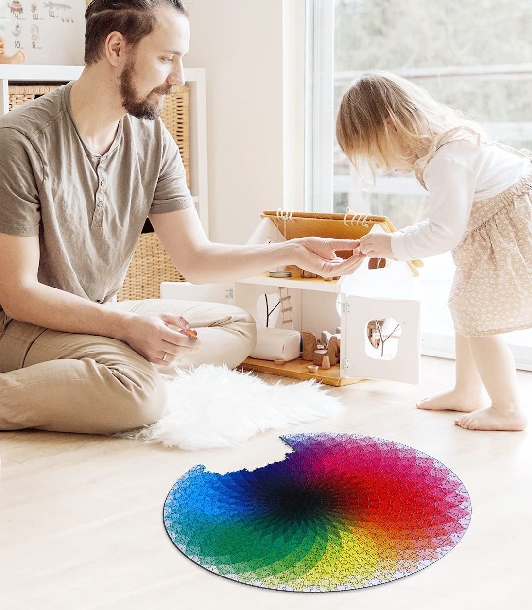 A person and child putting the puzzle together on the floor