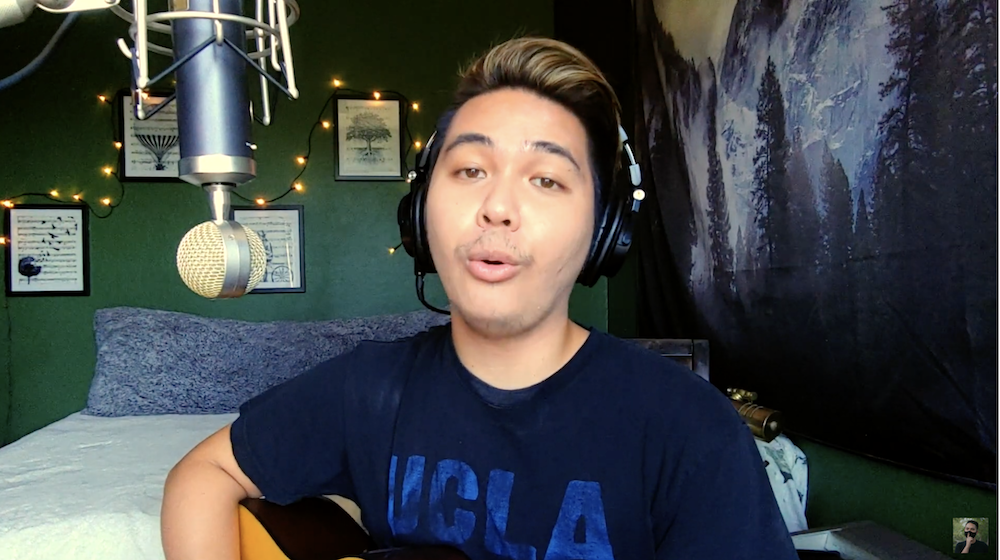 Topher singing in a video