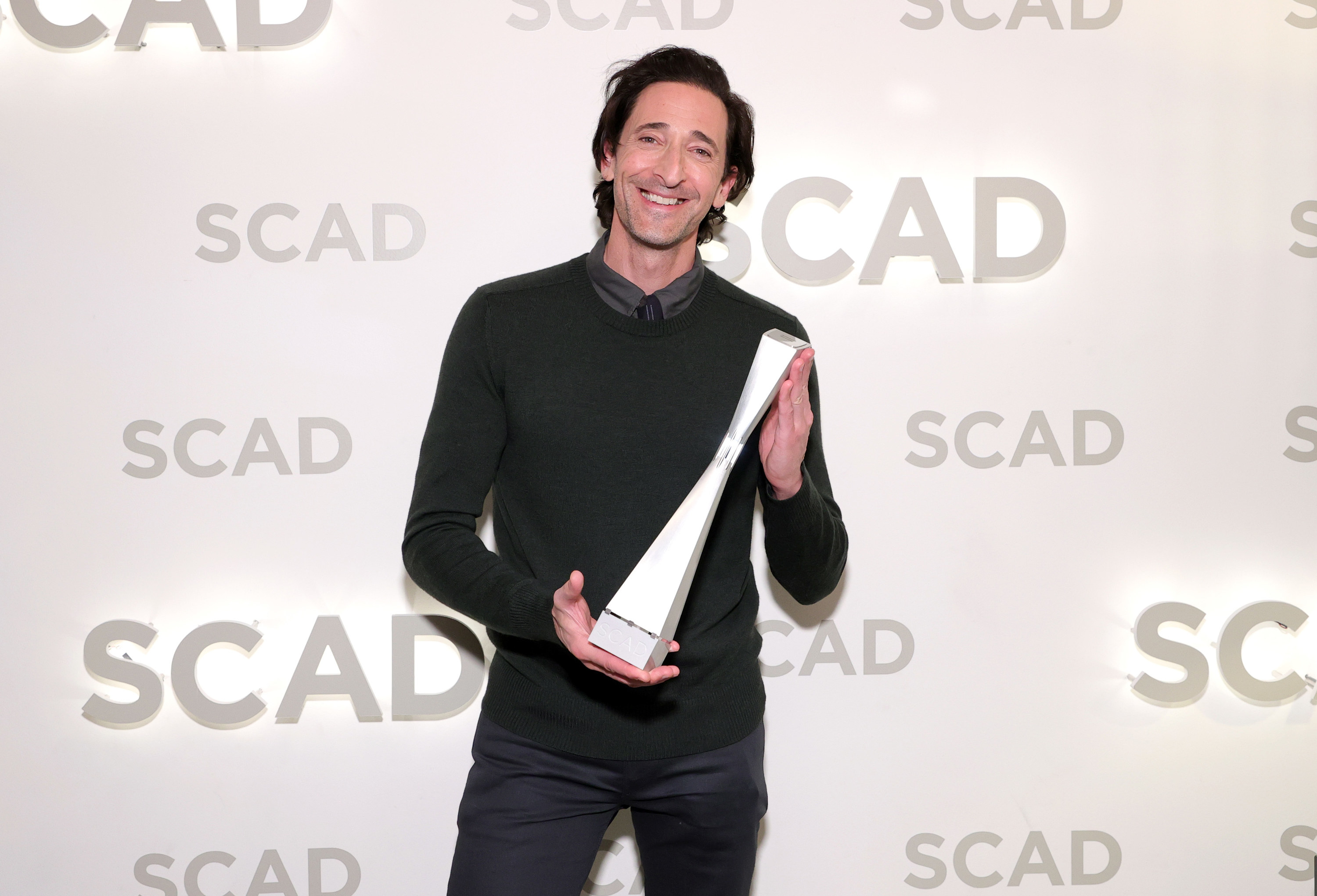 Brody holds an award