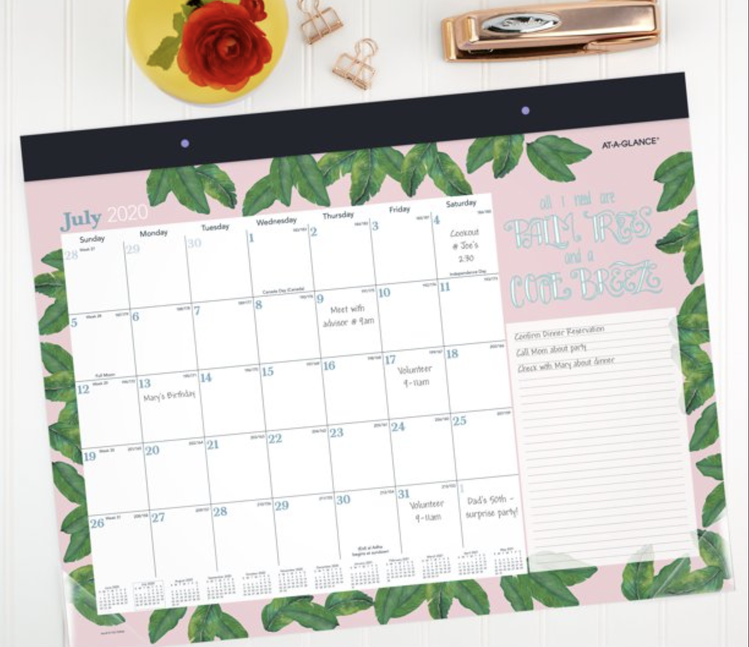 pink calendar with green leaves on a desk