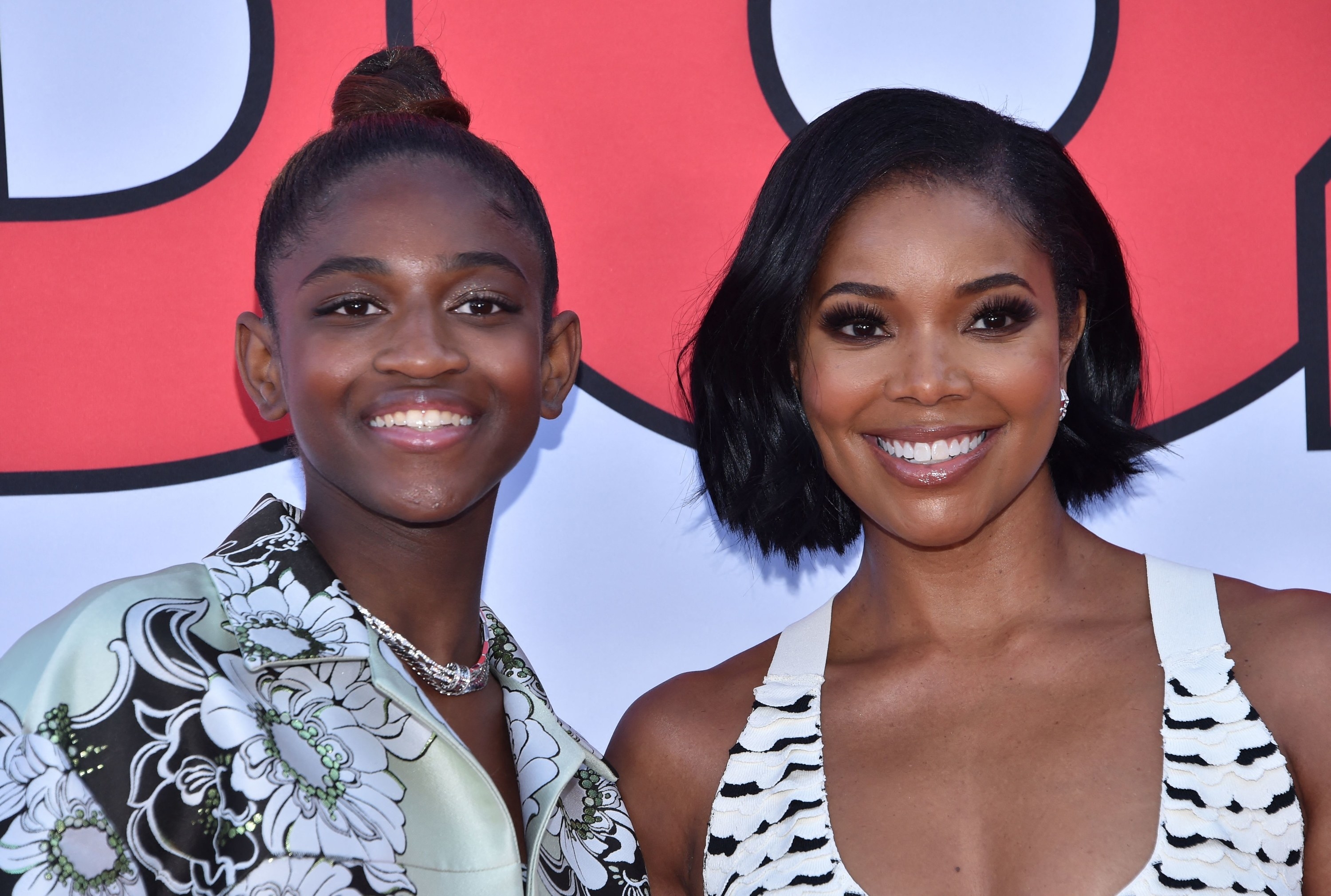 A closeup of Zaya and Gabrielle smiling at a red carpet premiere