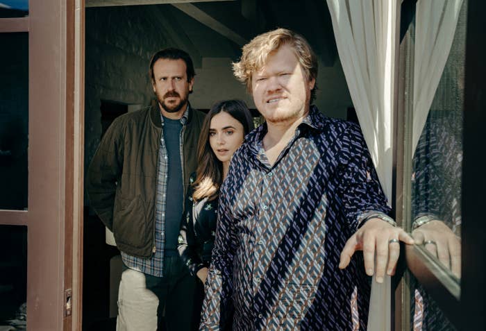 LILY COLLINS, JESSE PLEMONS and JASON SEGEL stand in a doorway and look at something