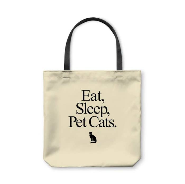 Neutral tote bag that says &quot;eat, sleep, pet cats&quot; and has a picture of a cat on it