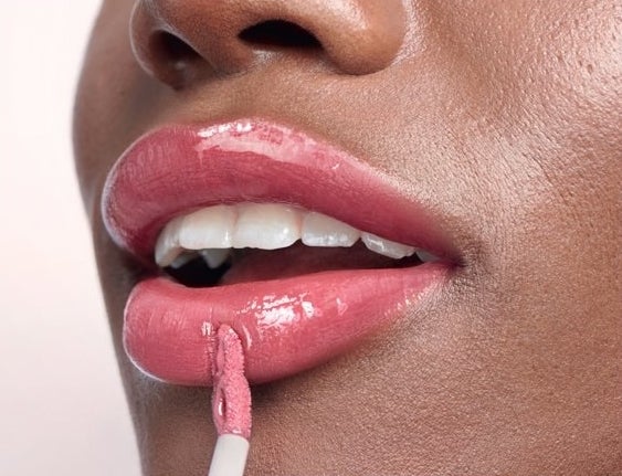 model wearing the lip gloss in pink