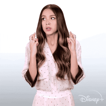 Olivia Rodrigo crosses her fingers for a &quot;High School Musical: The Musical: The Series&quot; promotional shoot