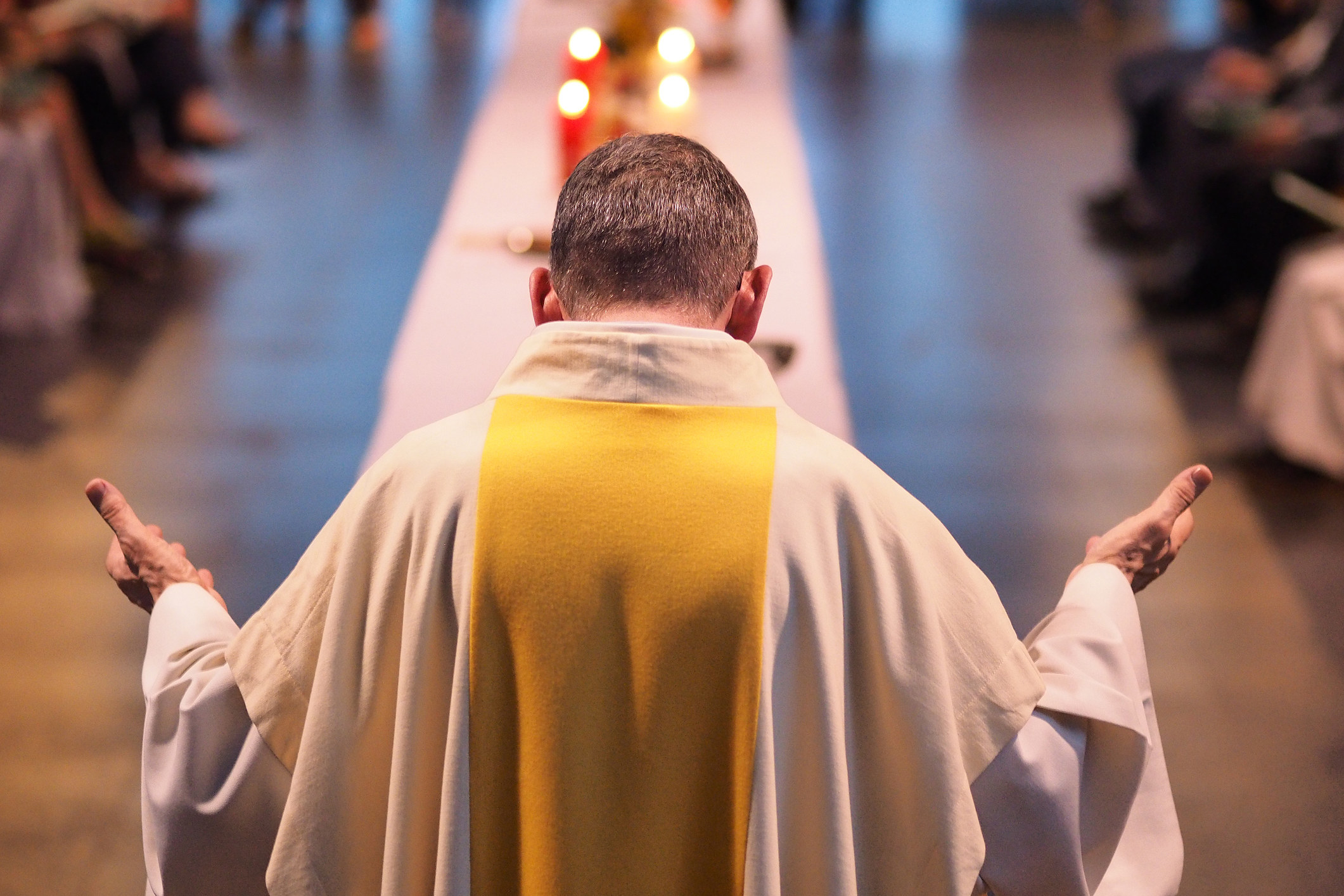 A priest preaching to a congregation