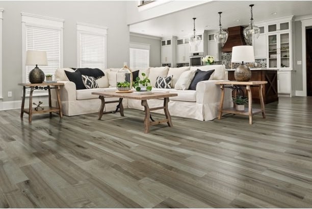 a decorated living room with the grey-brown vinyl floors