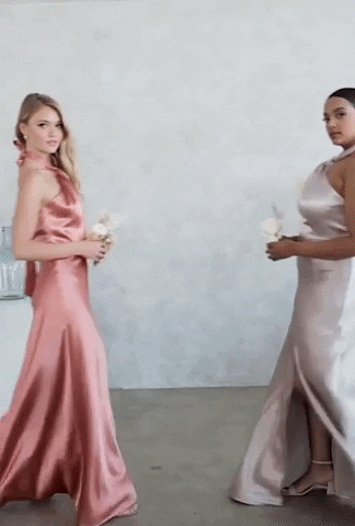a gif of two models posing in pink and taupe