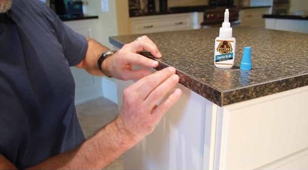 a model using the superglue on the edge of a counter