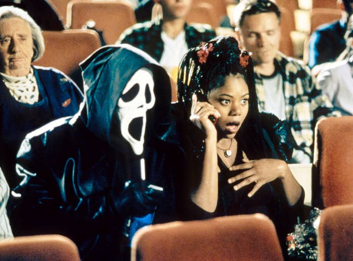 Regina Hall sits in a theater with ghostface