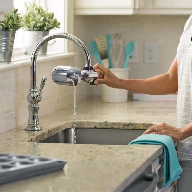 a model using a faucet with the silver filtration attachment