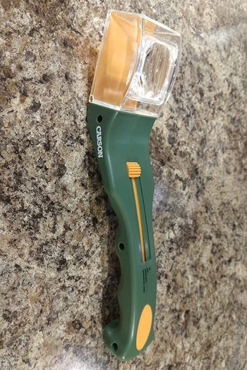 a reviewer photo of the bug catching tool